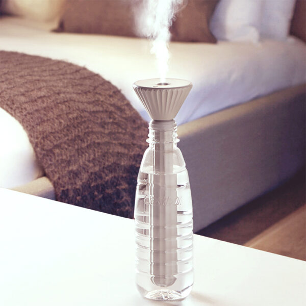 Portable humidifier for plants used in a bedroom, keeping plants hydrated while promoting restful sleep.