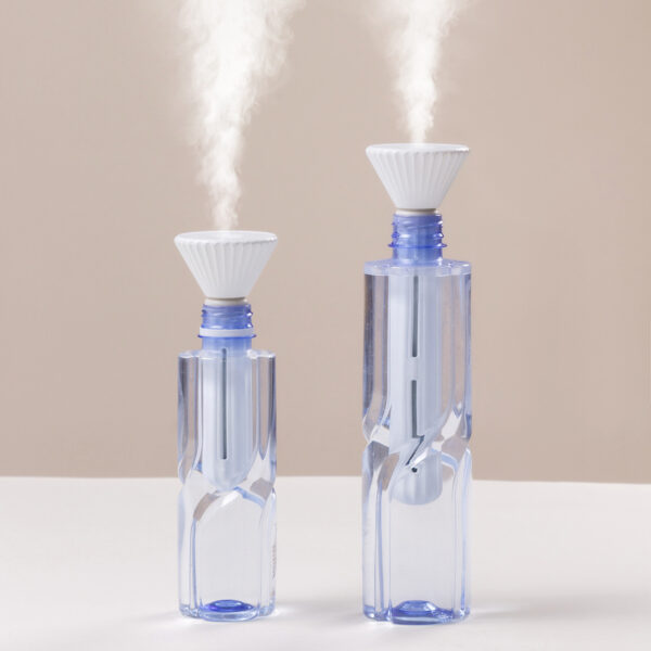 Portable humidifier for plants in use in a cozy indoor environment, delivering moisture for optimal plant growth.