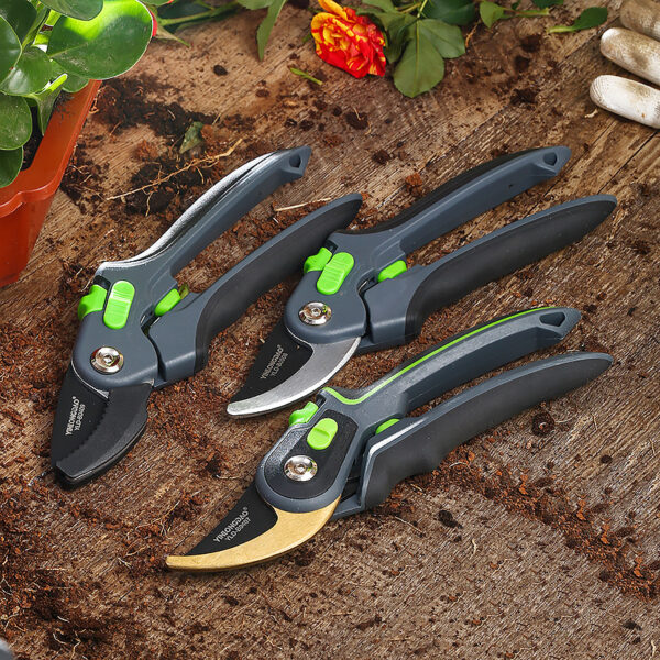 Pruning shears in Gold, Silver, and Black variations placed on the ground.