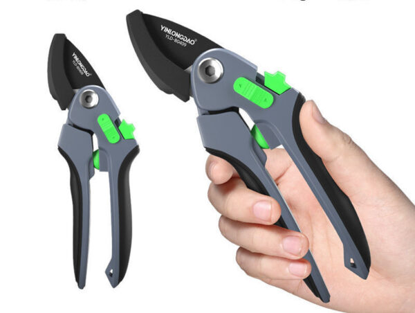 Black pruning shears in hand, ideal for precise branch cutting.