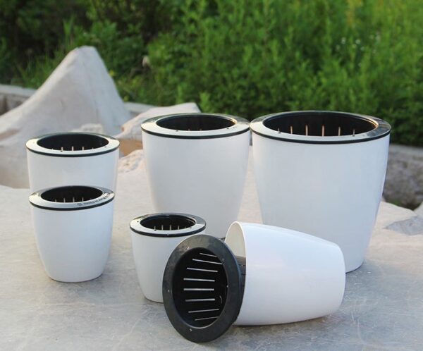 All sizes of the self watering pot on a wooden table