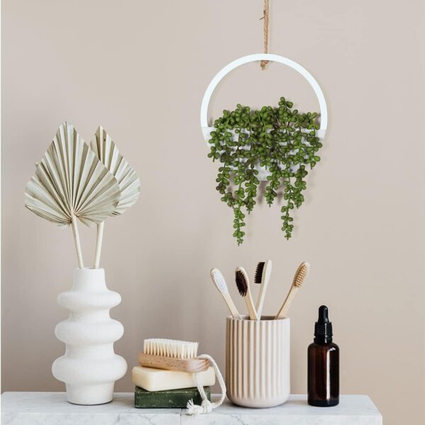 Single artificial hanging plant in white color, showcasing its versatility for different indoor uses.