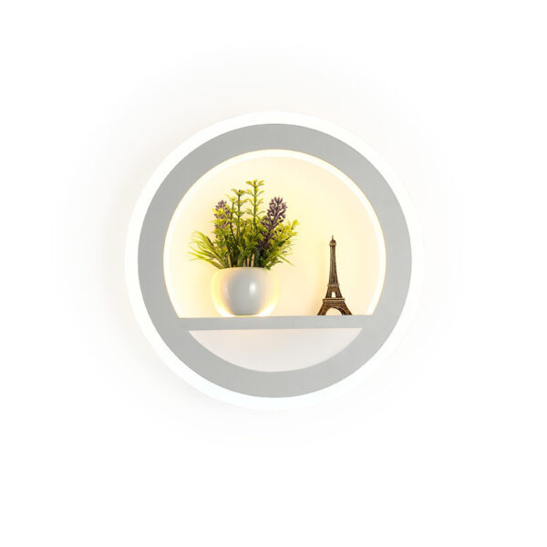 Decorative planter with Eiffel Tower and green plant inside